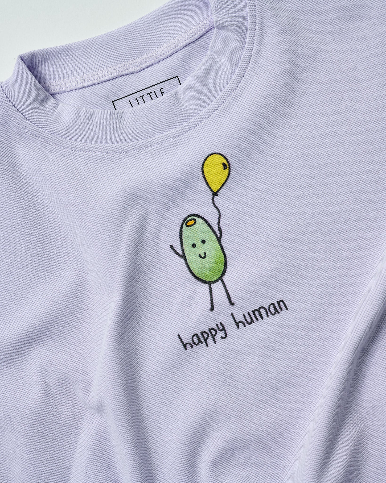 lilac romper with a olive character holding a yellow balloon and 'happy human' text.