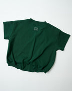 Back view of oversized forest green toddler romper showing the signature relaxed fit with Little Olives logo.