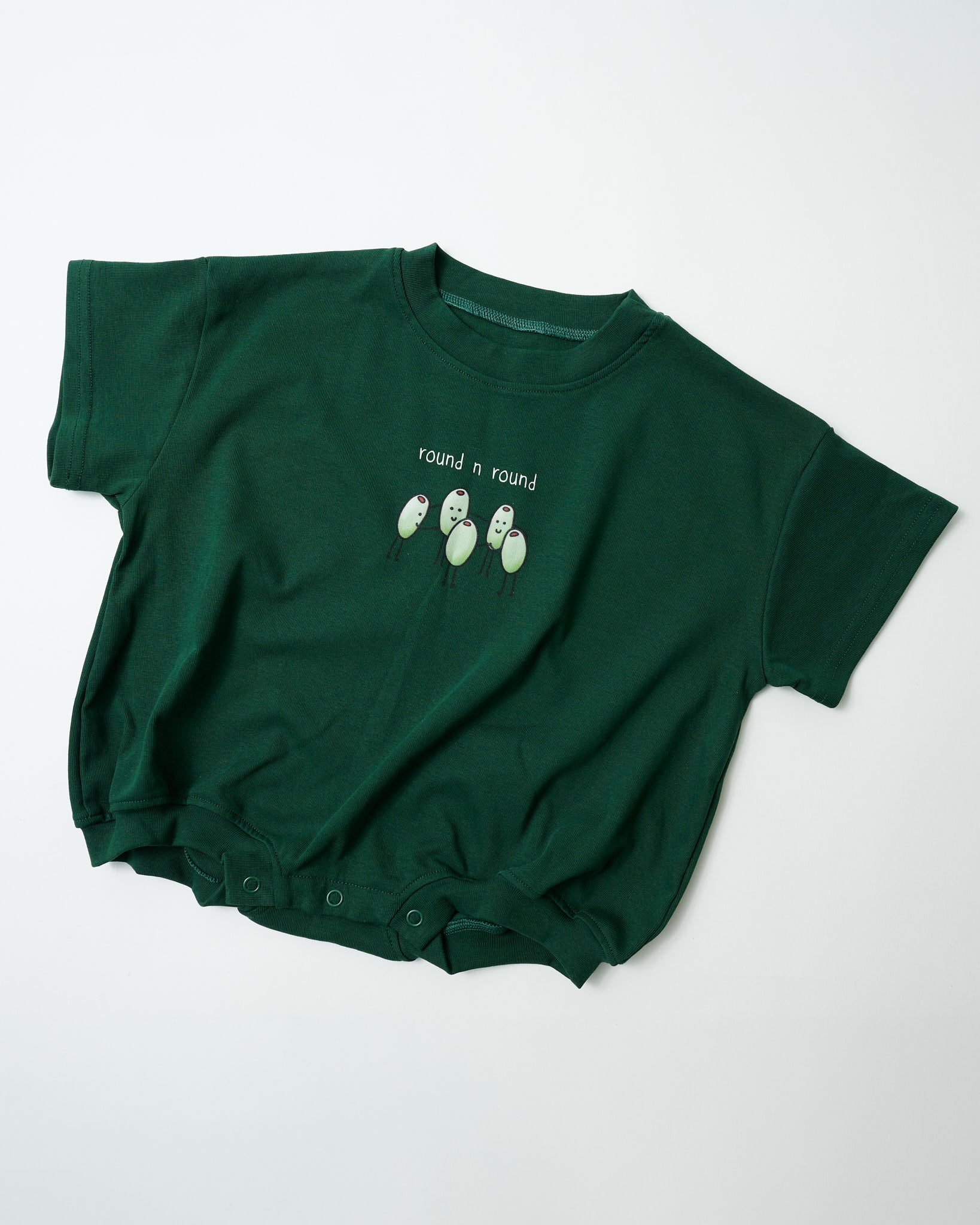 Front view of Round n Round baby romper in forest green organic cotton with circular olive print.