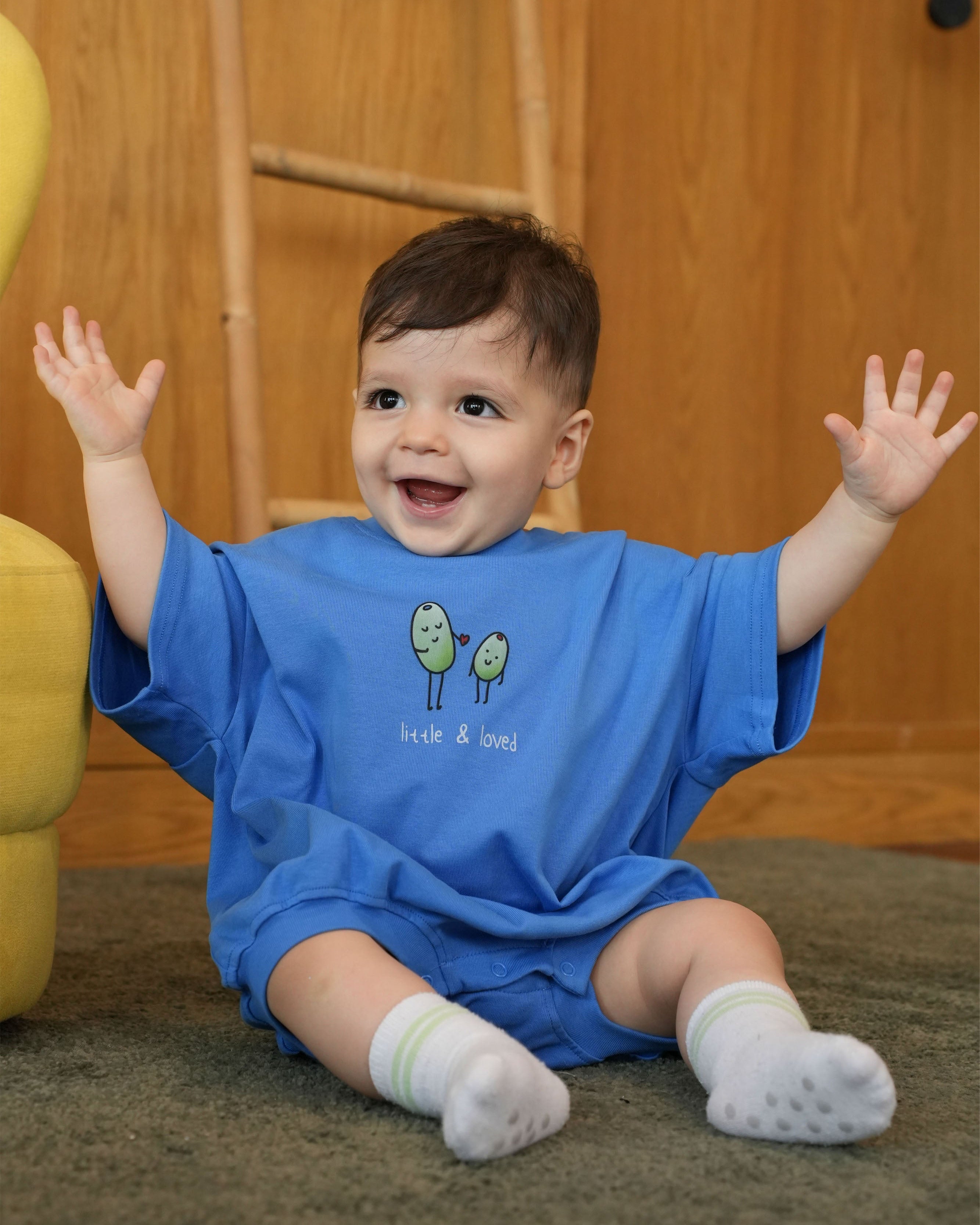 photo of a happy baby wearing the sky blue Little & Loved heart romper 